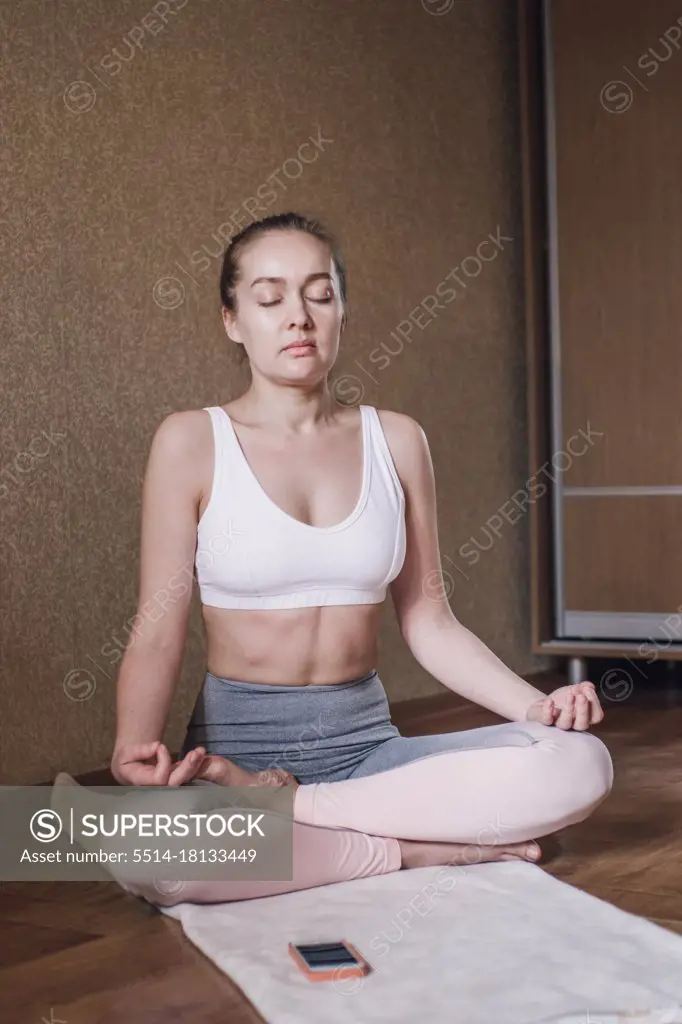 Portrait of woman meditating at home