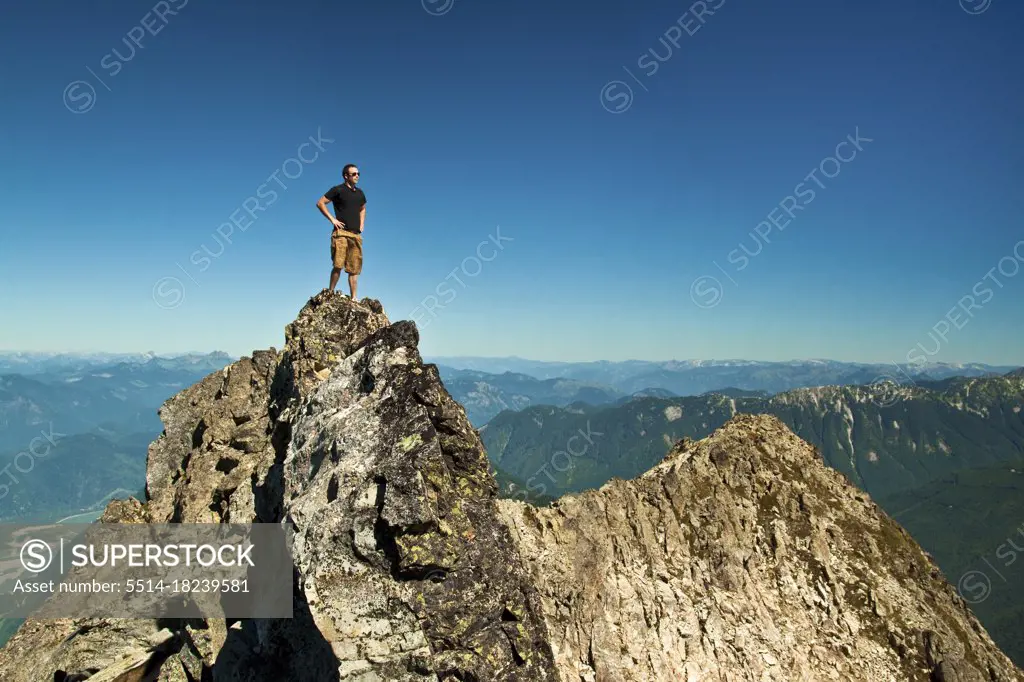 Hiker standing on mountain summit, Chilliwack, B.C. Canada.