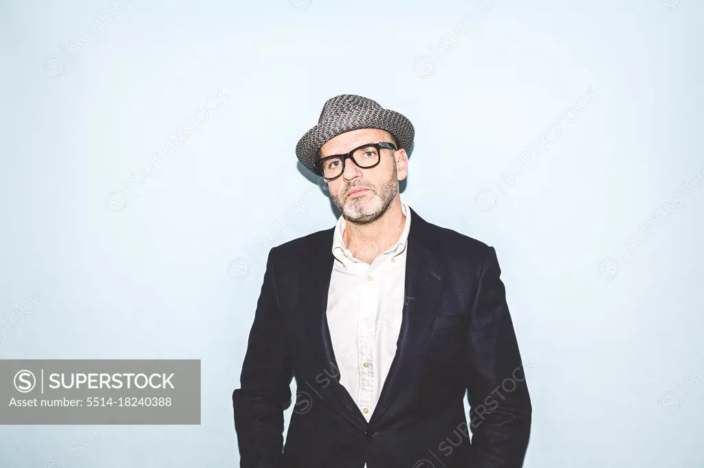 Portrait of attractive man in hat and glasses