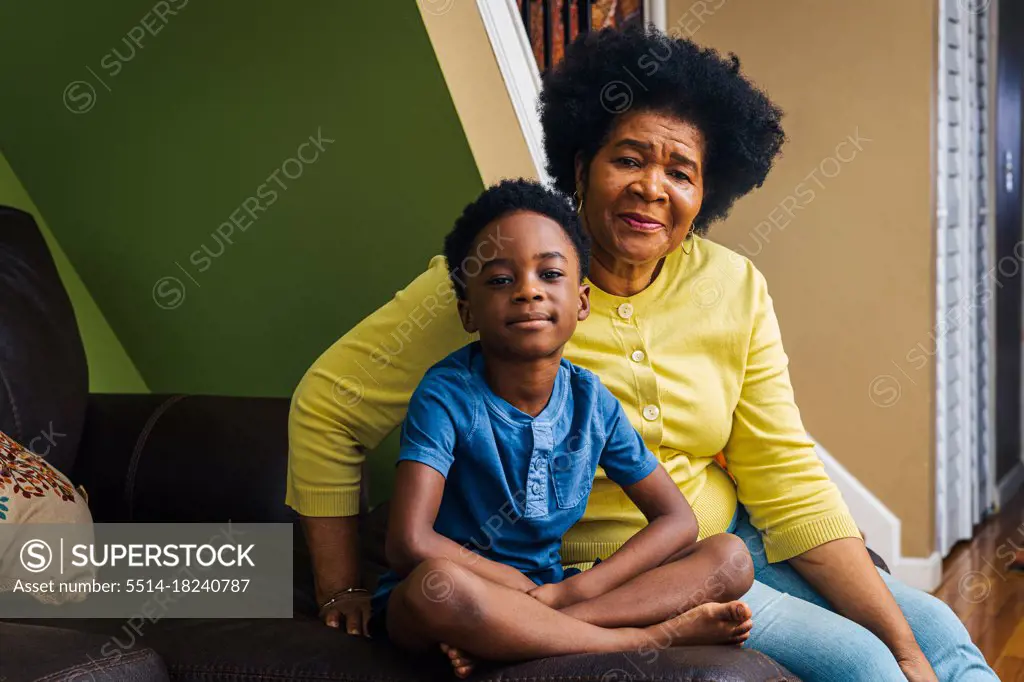 Portrait of cute smiling boy with grandmother at home