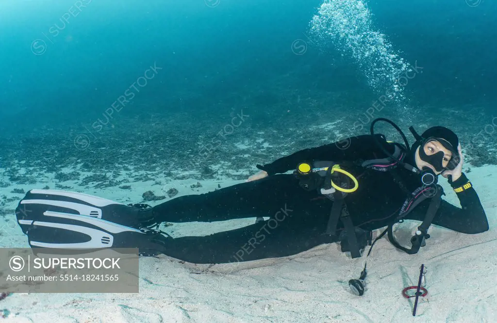 woman relaxing on ocean floor in Raja Ampat