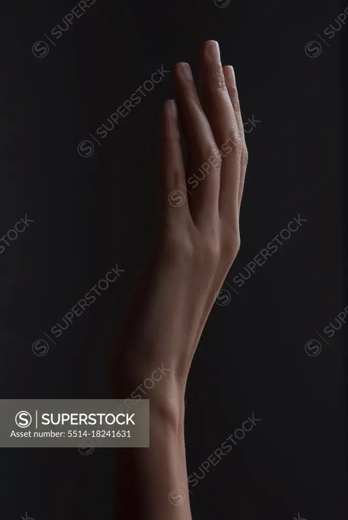 hand forming shade next to a wall