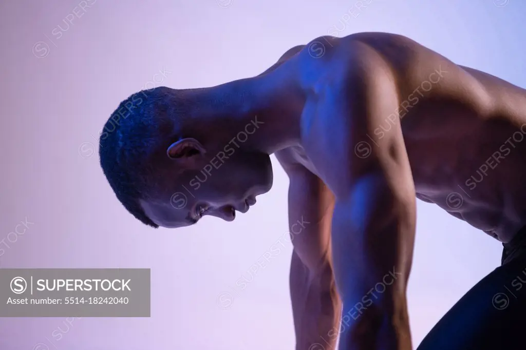 Black male sprinter in crouch start position