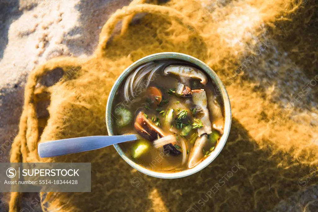 Vertical shot of soup while beach car camping