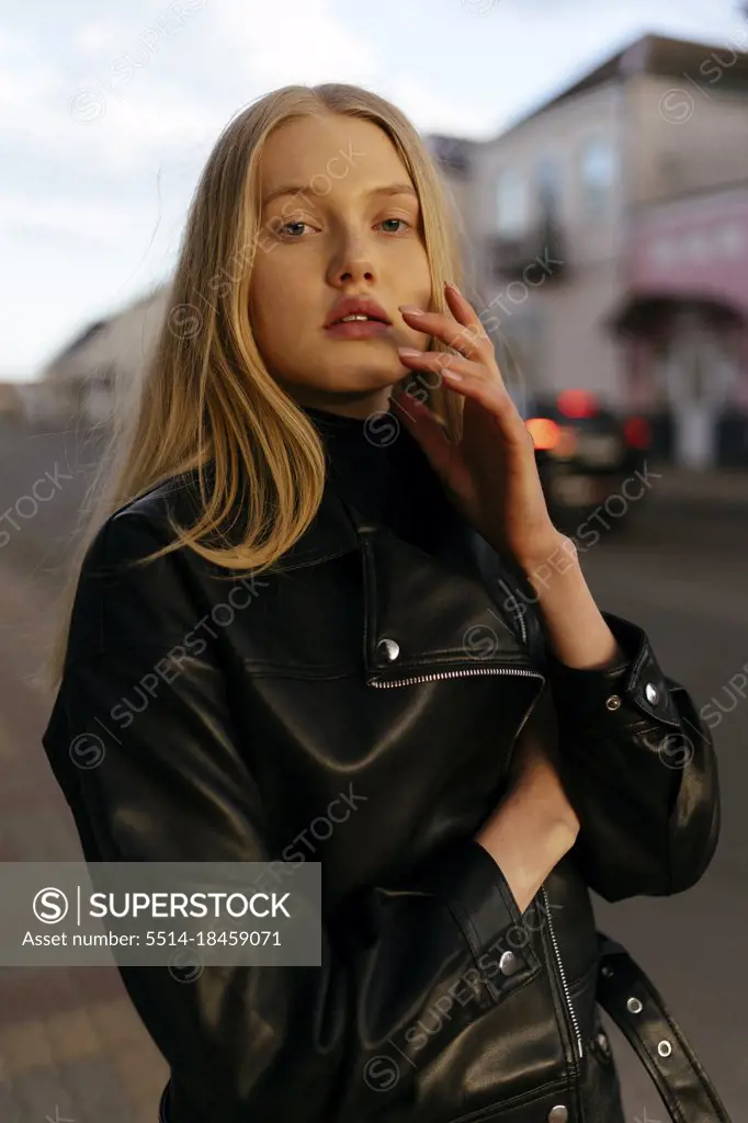 Stylish blonde woman with in leather black jacket