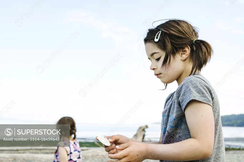 Side closeup view of a young girl on a Seattle beach