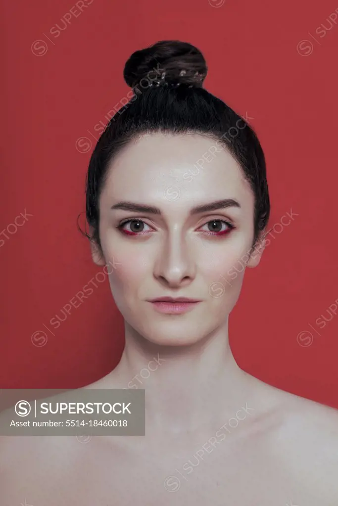 Confident woman seriously looking on red
