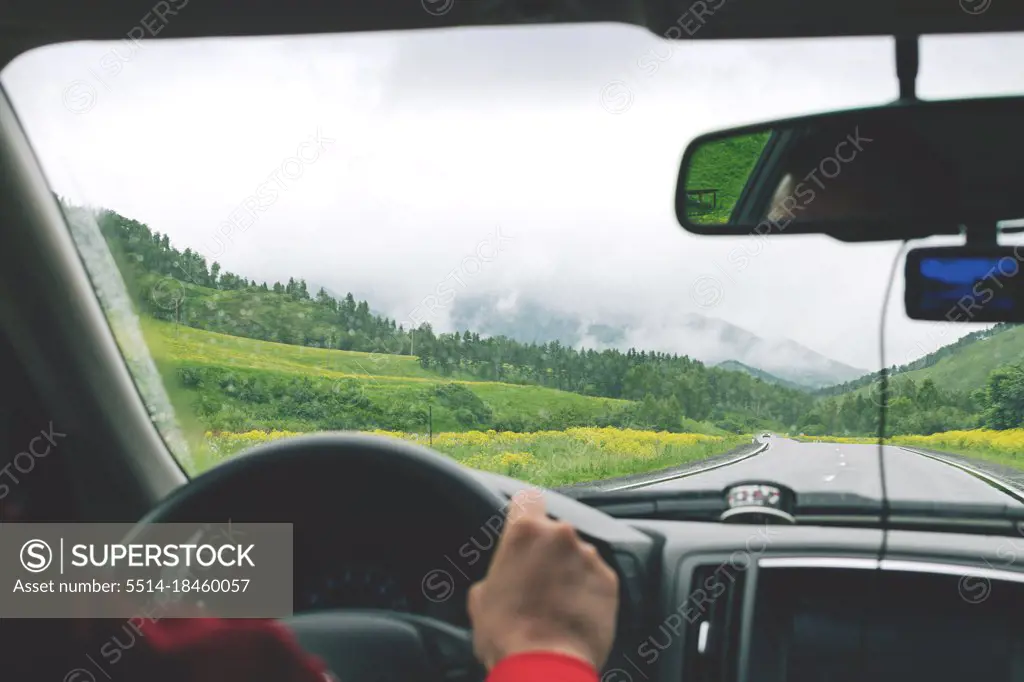 Man driving car on country road in Altai mountains.