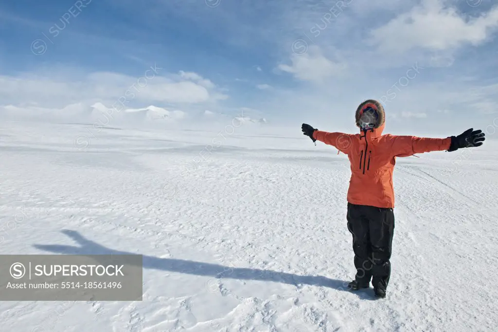 young woman leaning into the wind on Vatnajokull glacier