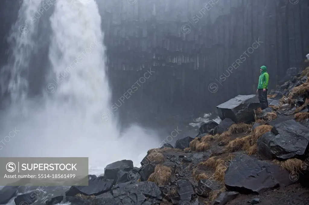 Woman looking at Svartifoss waterfall at Skaftafell