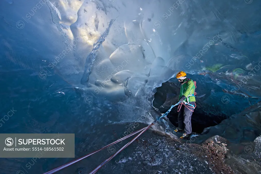 Woman exploring icecave on Svinafellsjokull glacier