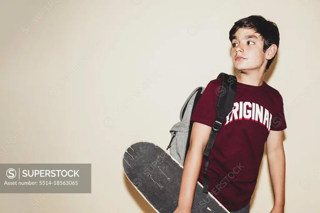 Beautiful boy  with skate in studio
