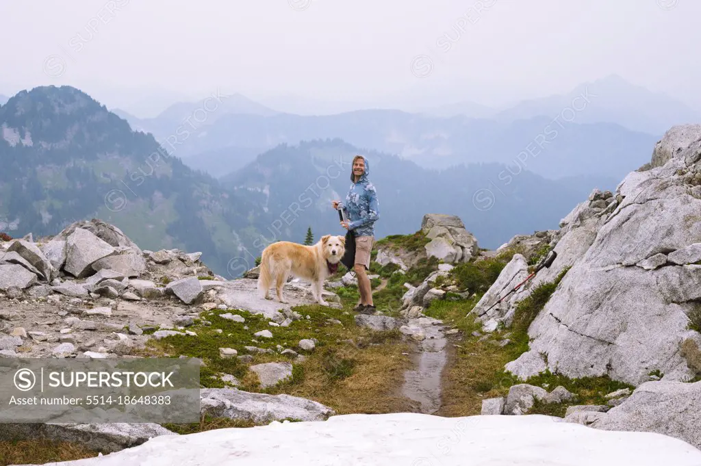 Hiker and dog smiling in the north cascade mountains alpine