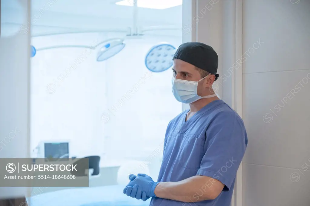 Male surgeon before starting operation in operating room