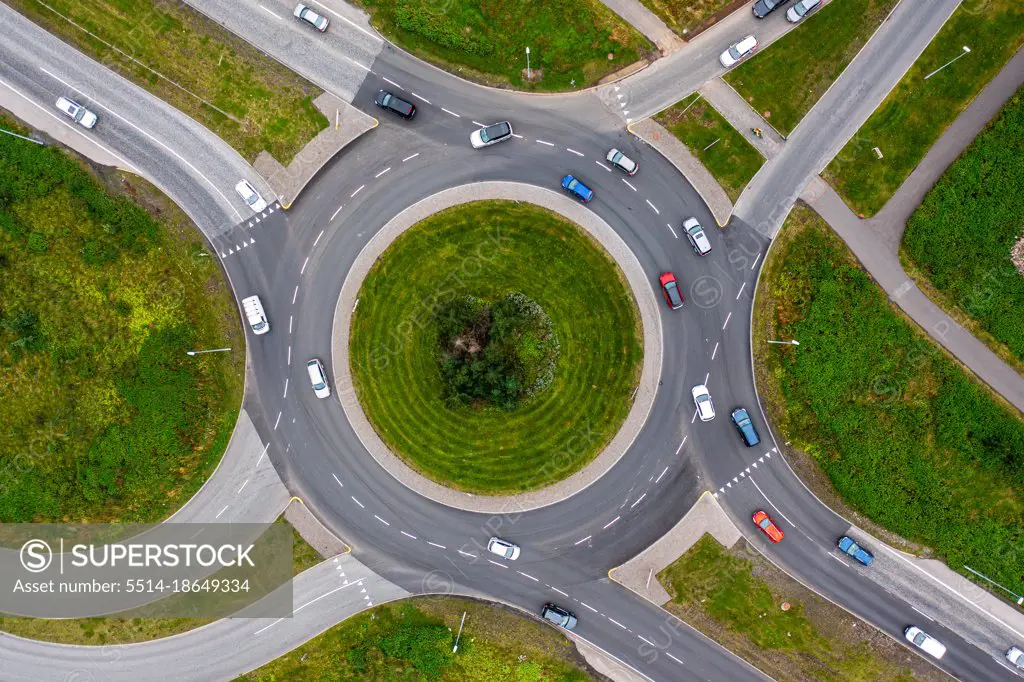 Roundabout on green landscape seen from above.