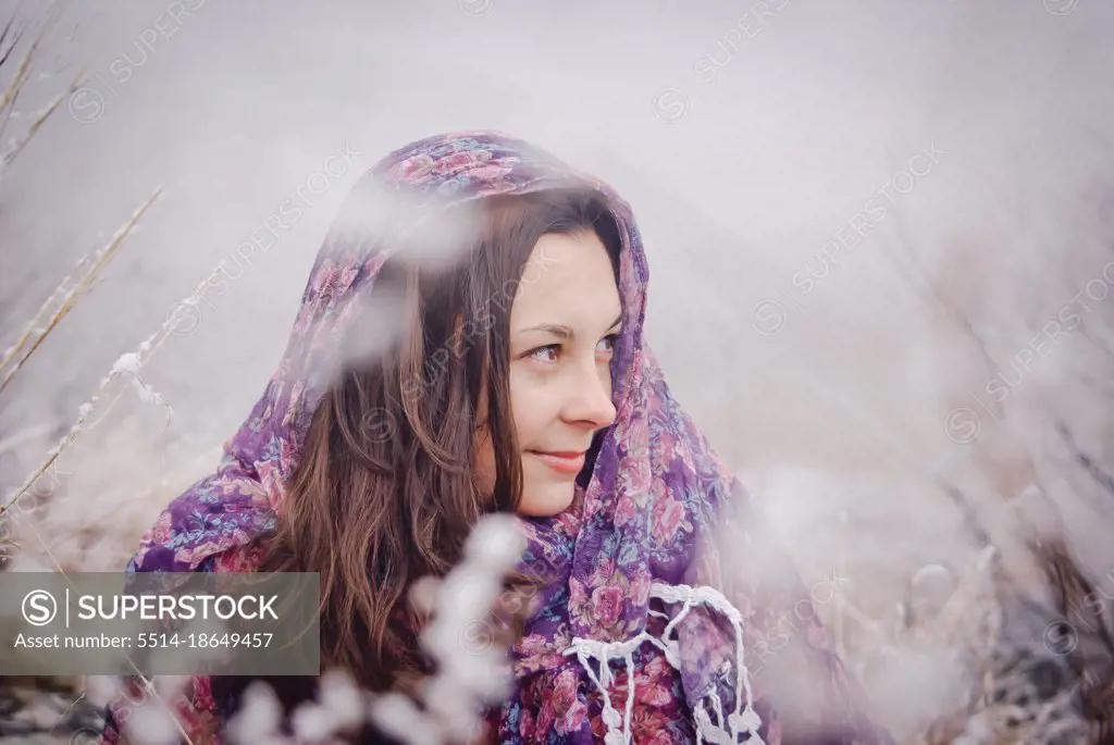 woman among snowy trees in winter forest