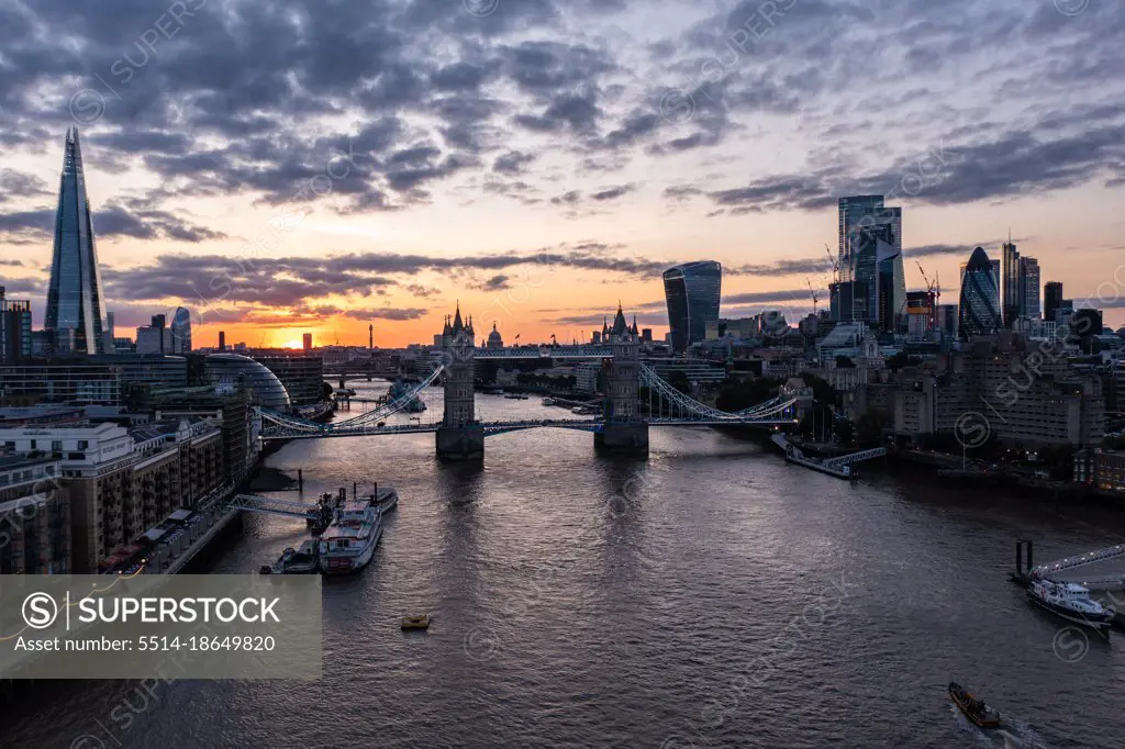 Tower Bridge over Thames River surrounded with buildings in London