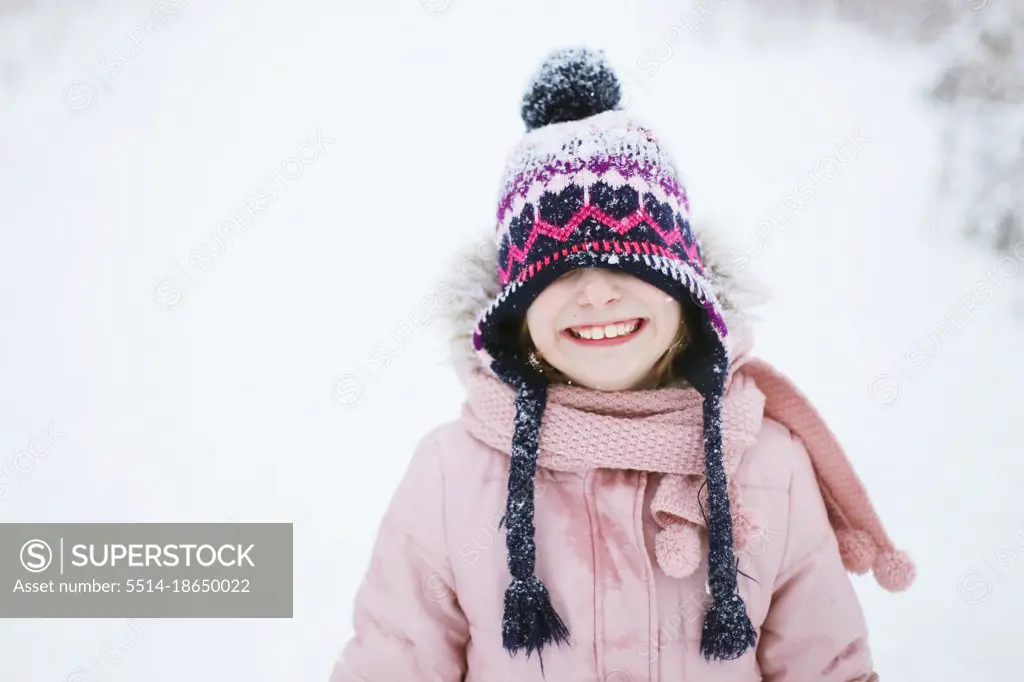 Portrait of a girl in a hat in winter on the street
