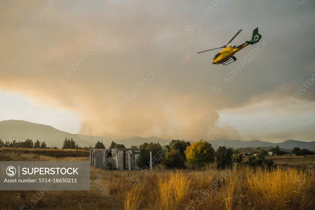 Emergency. Helicopter flying to forest fire Sixth generation fire.
