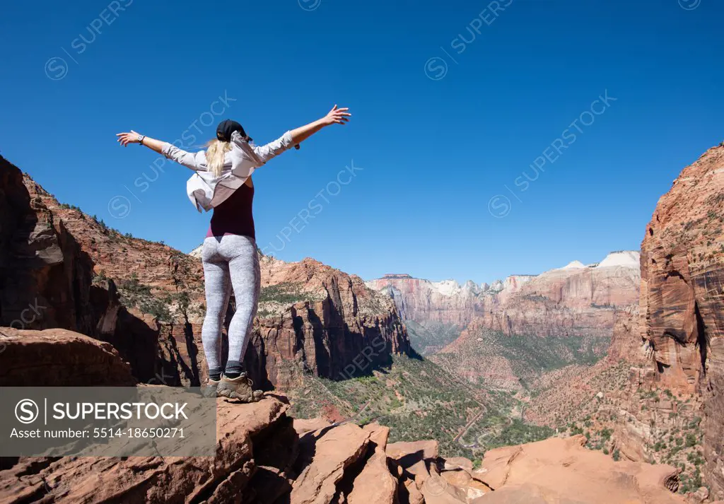 Girl With Hands Up Takes In View Of Zion National Park, Utah