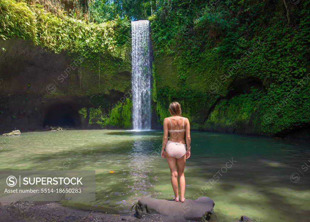 Girl At Tranquil Waterfall In Bali Indonesia