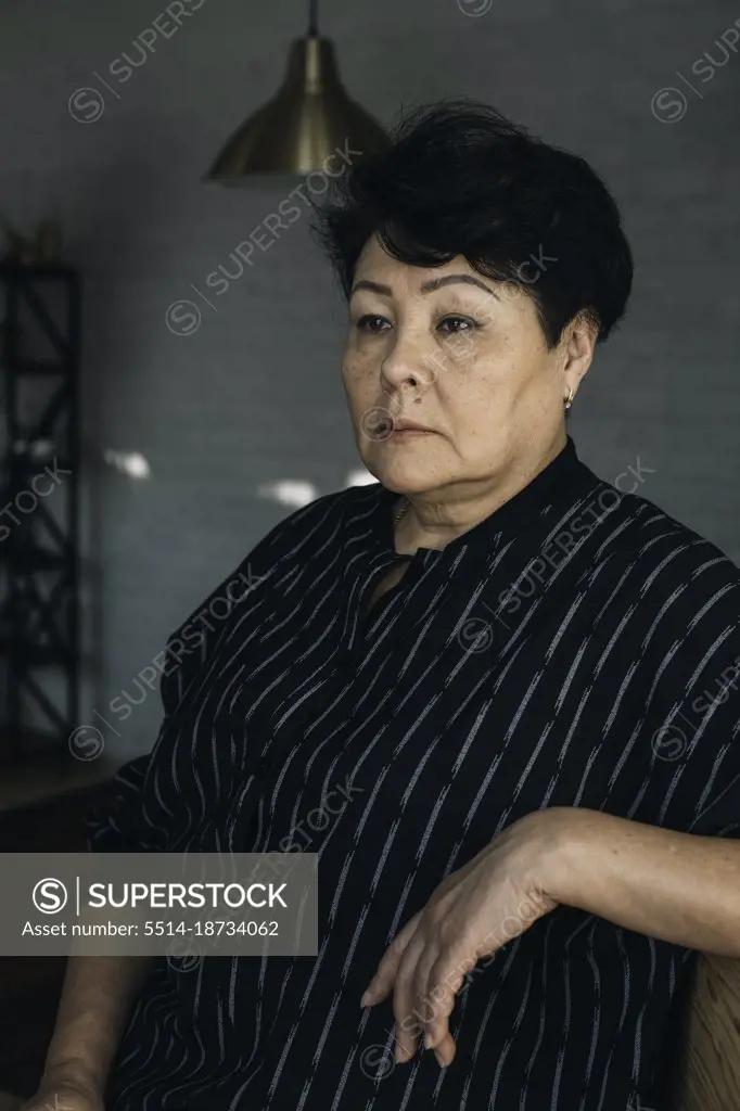 Portrait of an attractive elegant senior woman relaxing at home.