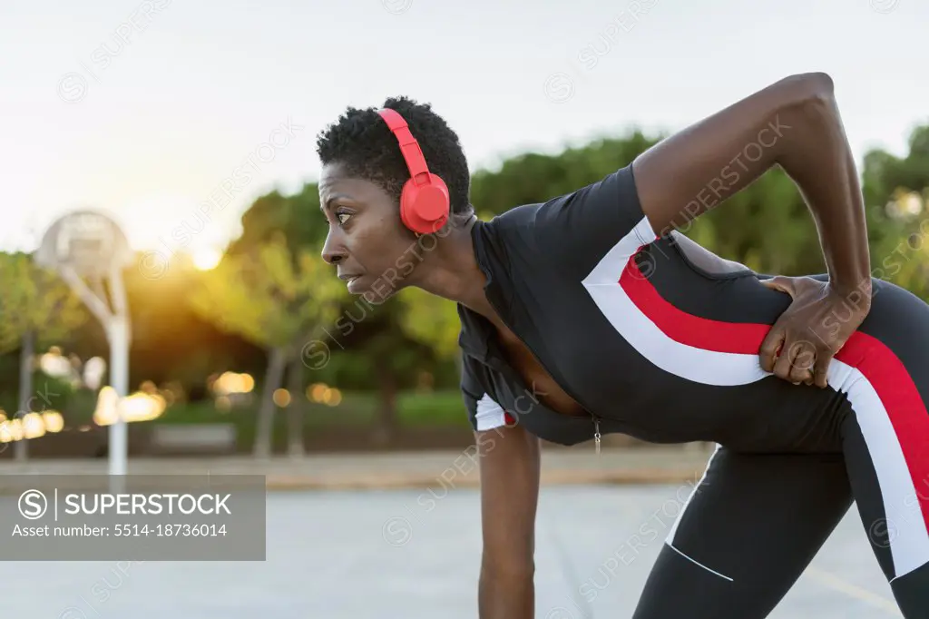 Portrait of african american female exercising and listening music