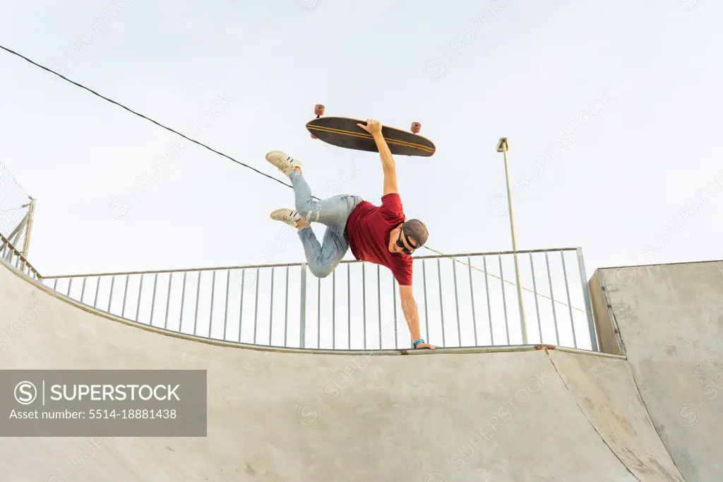 Adult man performing trick ramp with a Skate surf
