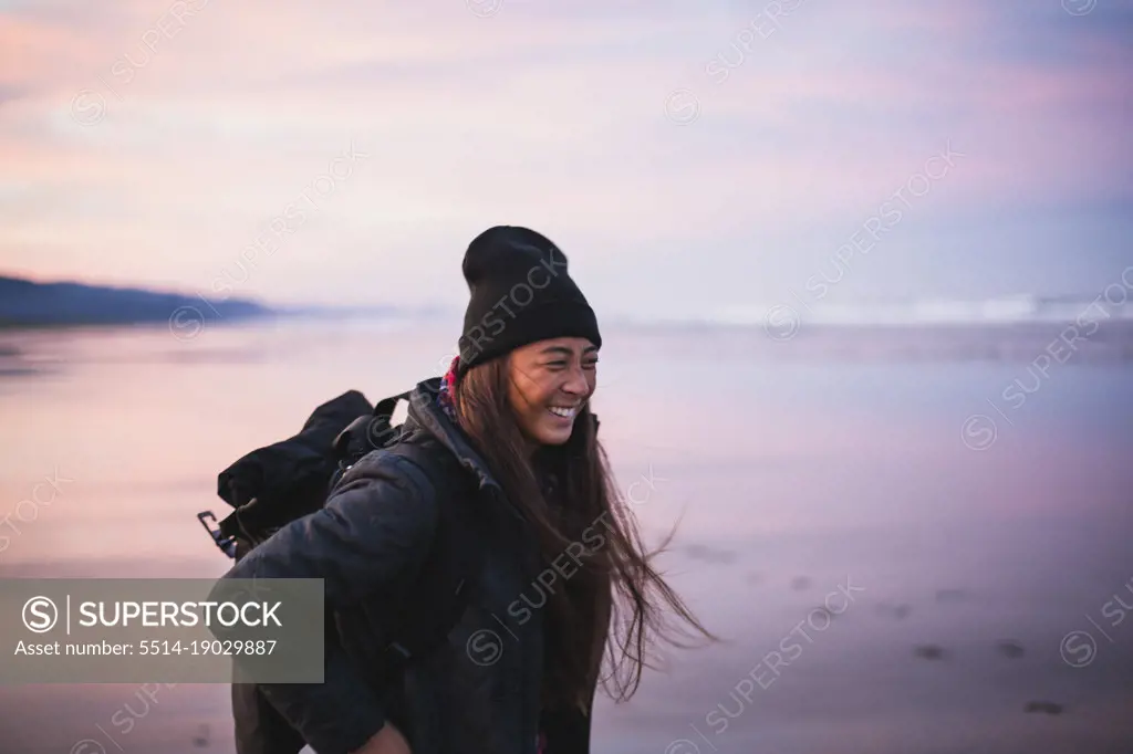 Smiling Young Woman on Oregon beach at sunrise