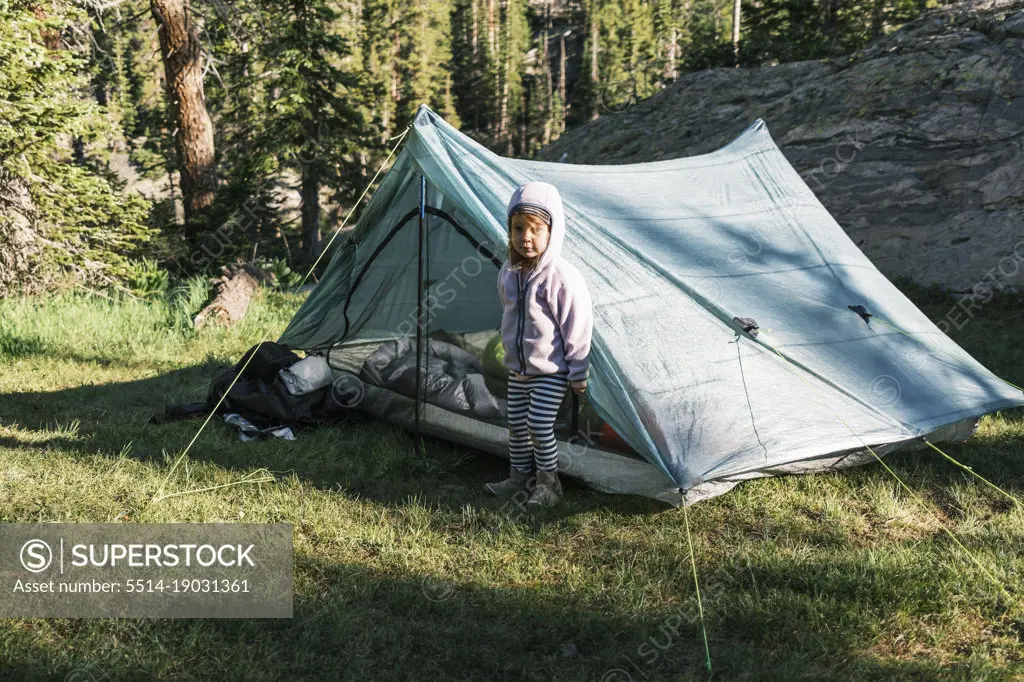 Young girl standing in front of her tent in Colorado