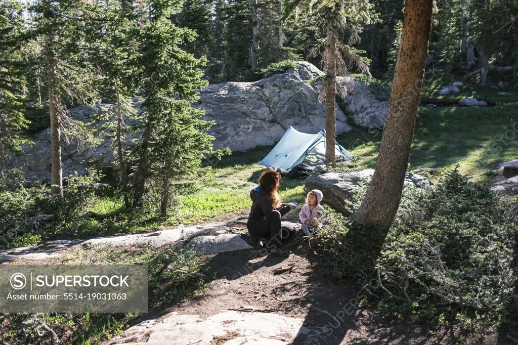 Mother and daughter resting near their camp in Colorado