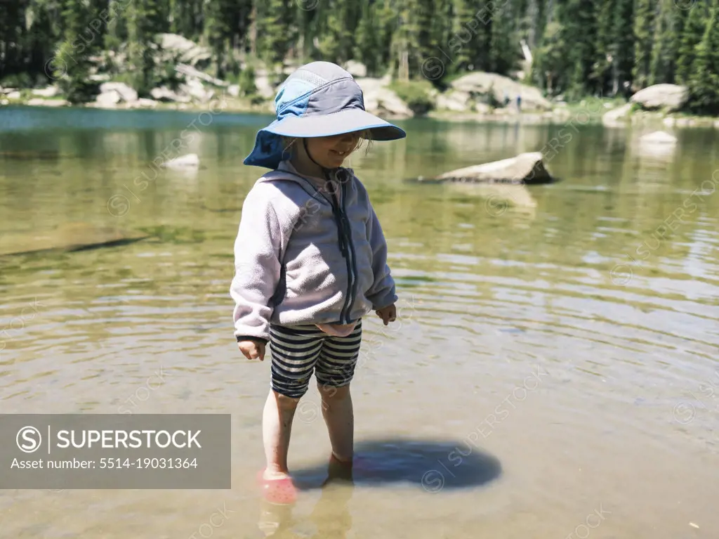 Girl standing in the shallow water of Brady Lake, Colorado