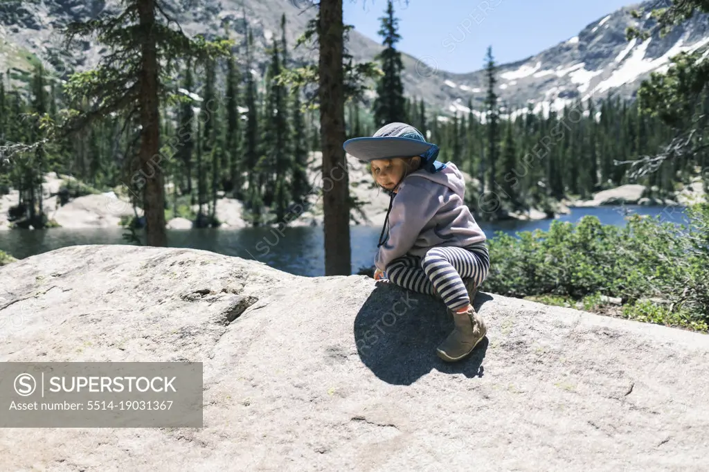Girl resting on a boulder above Sopris Lake, Colorado