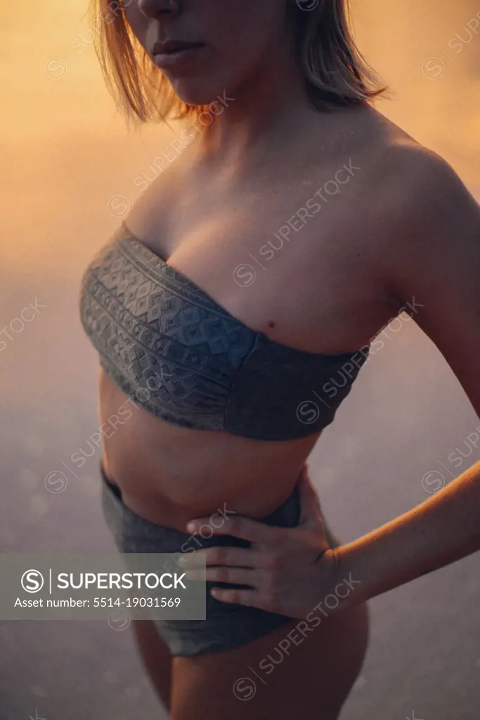 beauty girl wearing a bikini during the golden hour