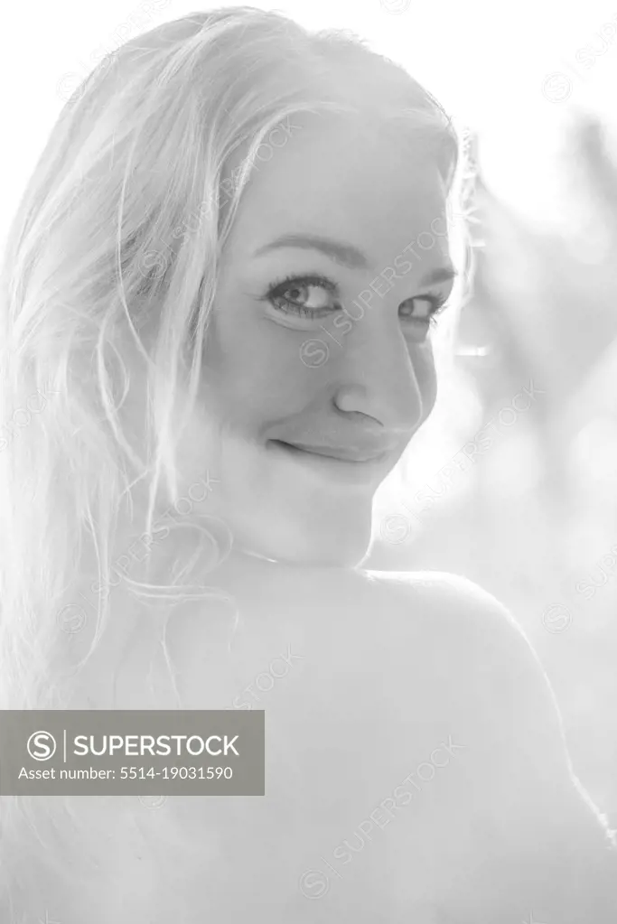 backlighting black and white close portrait of a blond girl