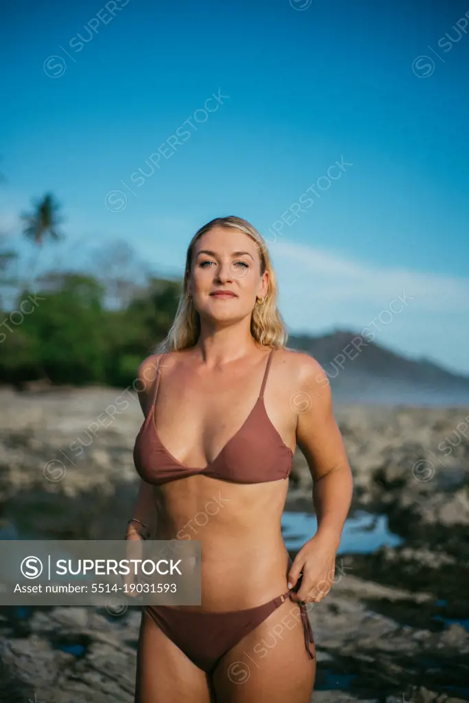 surfer girl wearing a bikini on the beach