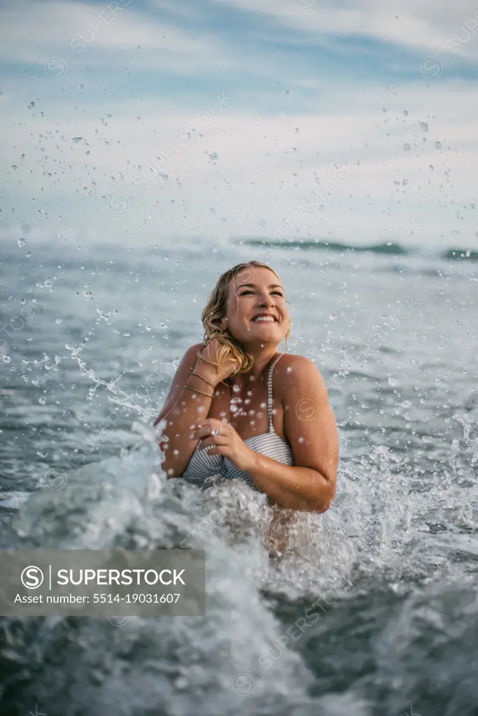 happy surfer girl playing and enjoying a beach day