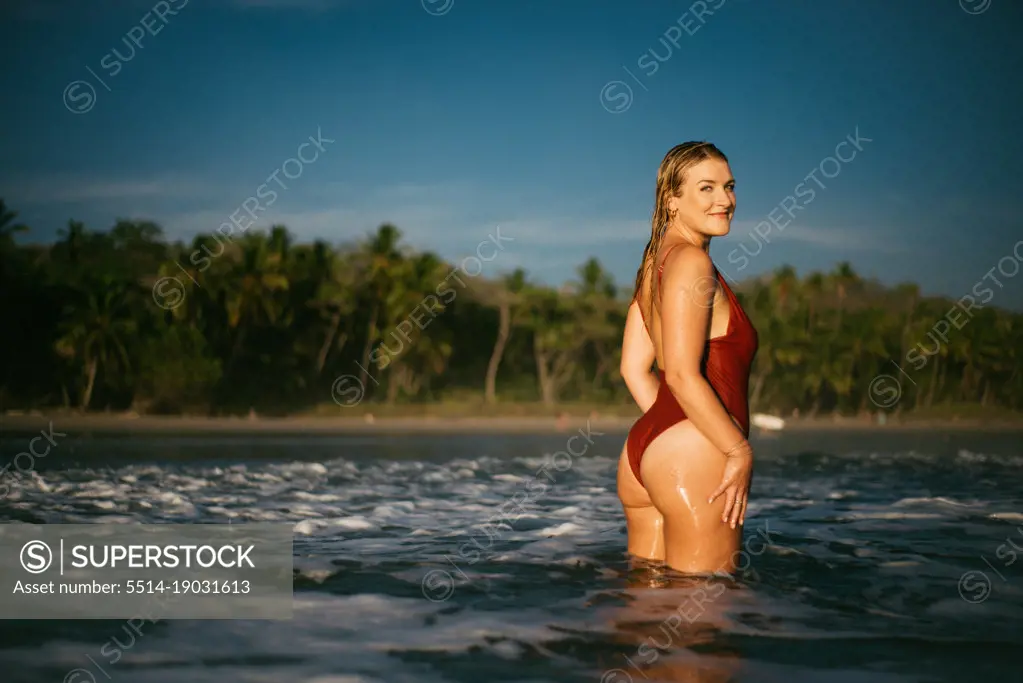 beauty blond girl wearing a red bikini on the Costa Rica beach