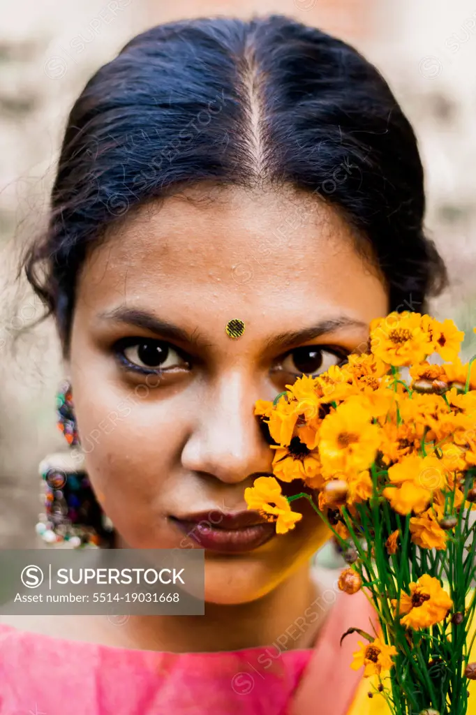 Portrait of a woman posing with flower
