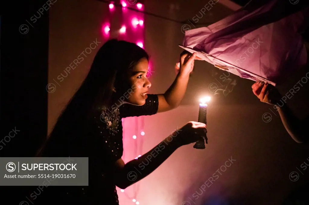 Photo of a girl holding candle in India