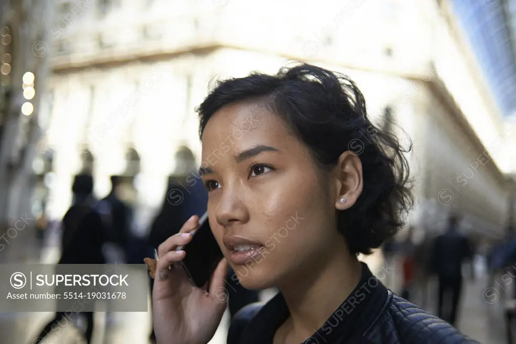 Asian female tourist talking on her mobile phone