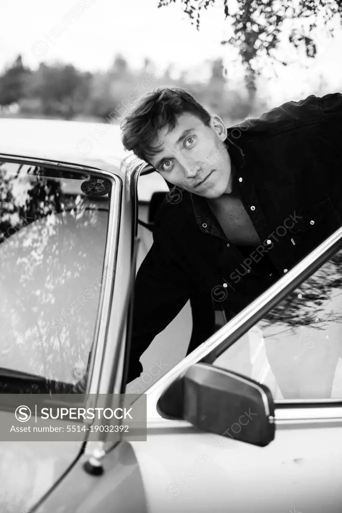 man with a car on a nature black and white