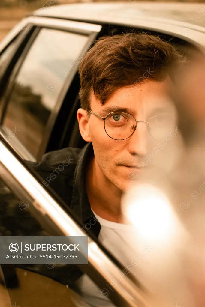 handsome man in glasses in car