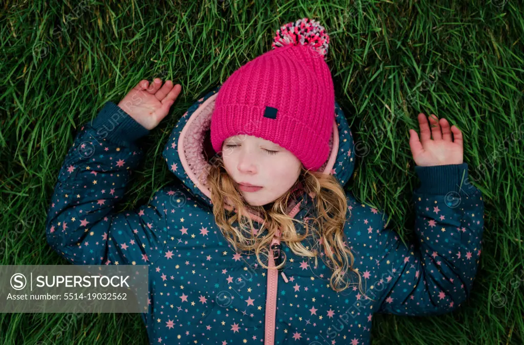 girl relaxing in the grass outside in the fresh air