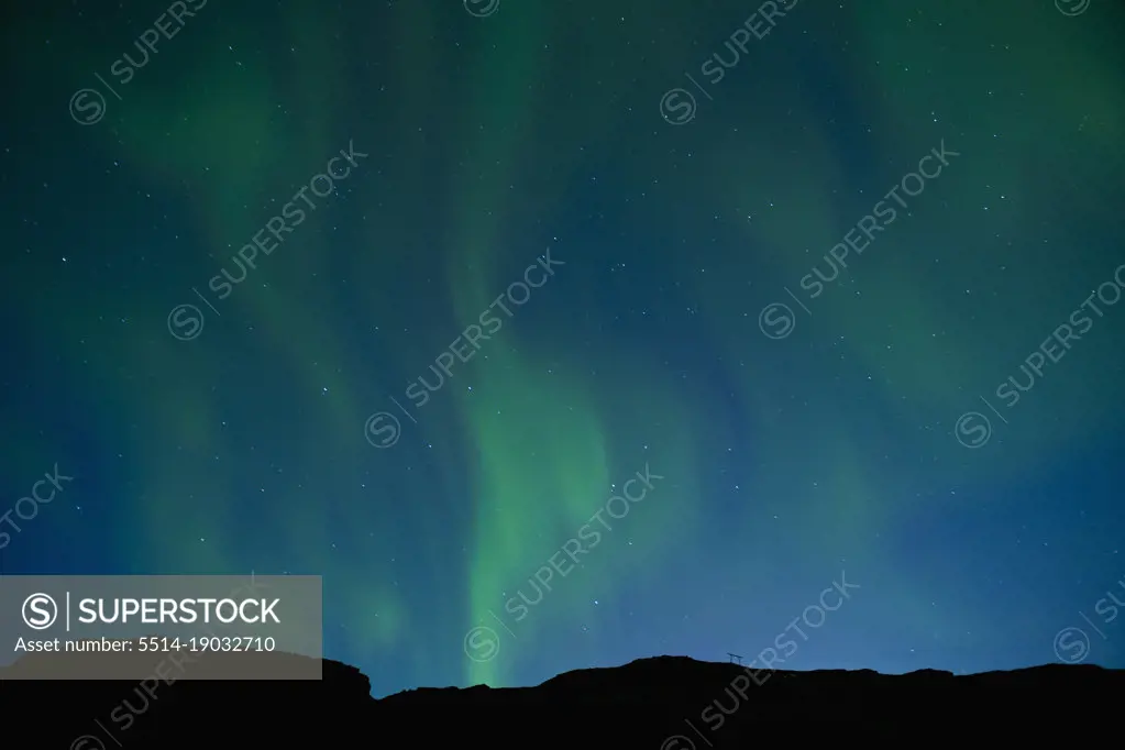 Aurora Borealis or Northern lights dancing in the sky above  Iceland