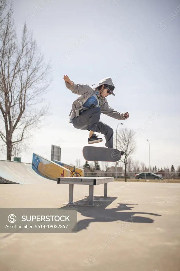 Young skateboard enthusiast doing a kickflip