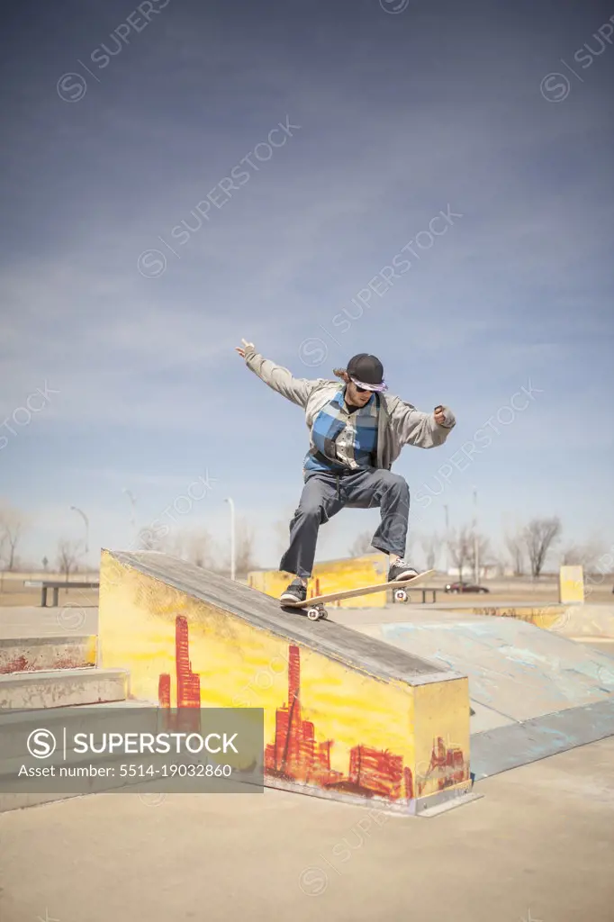 Young skateboarder grinding on ledge