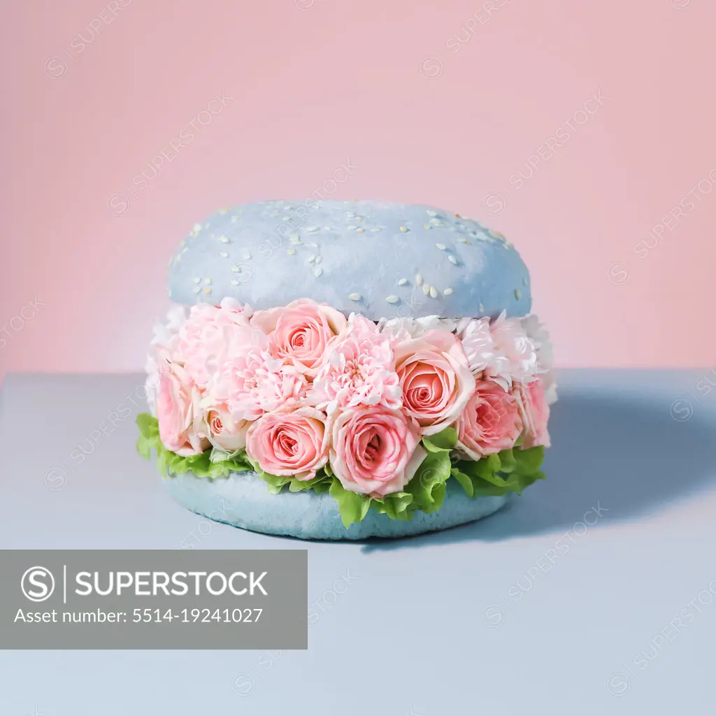 food vegan burgers with flowers on pink background