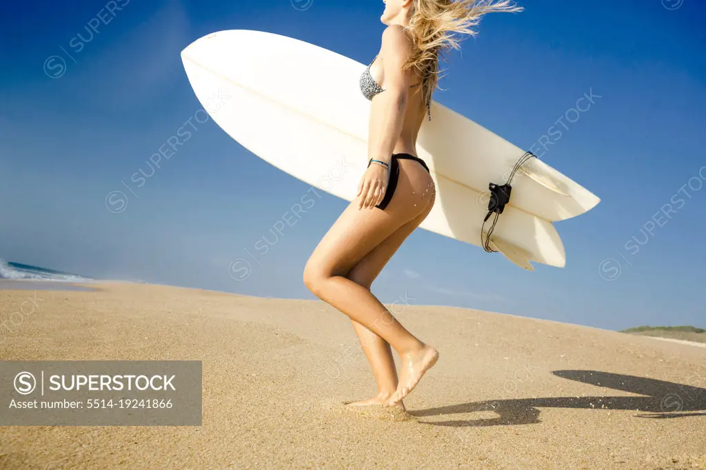 Surfer girl ready to hit the waves