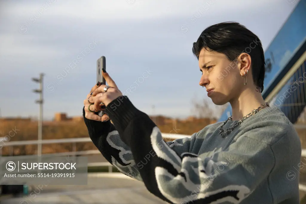 Girl taking photo through her smartphone